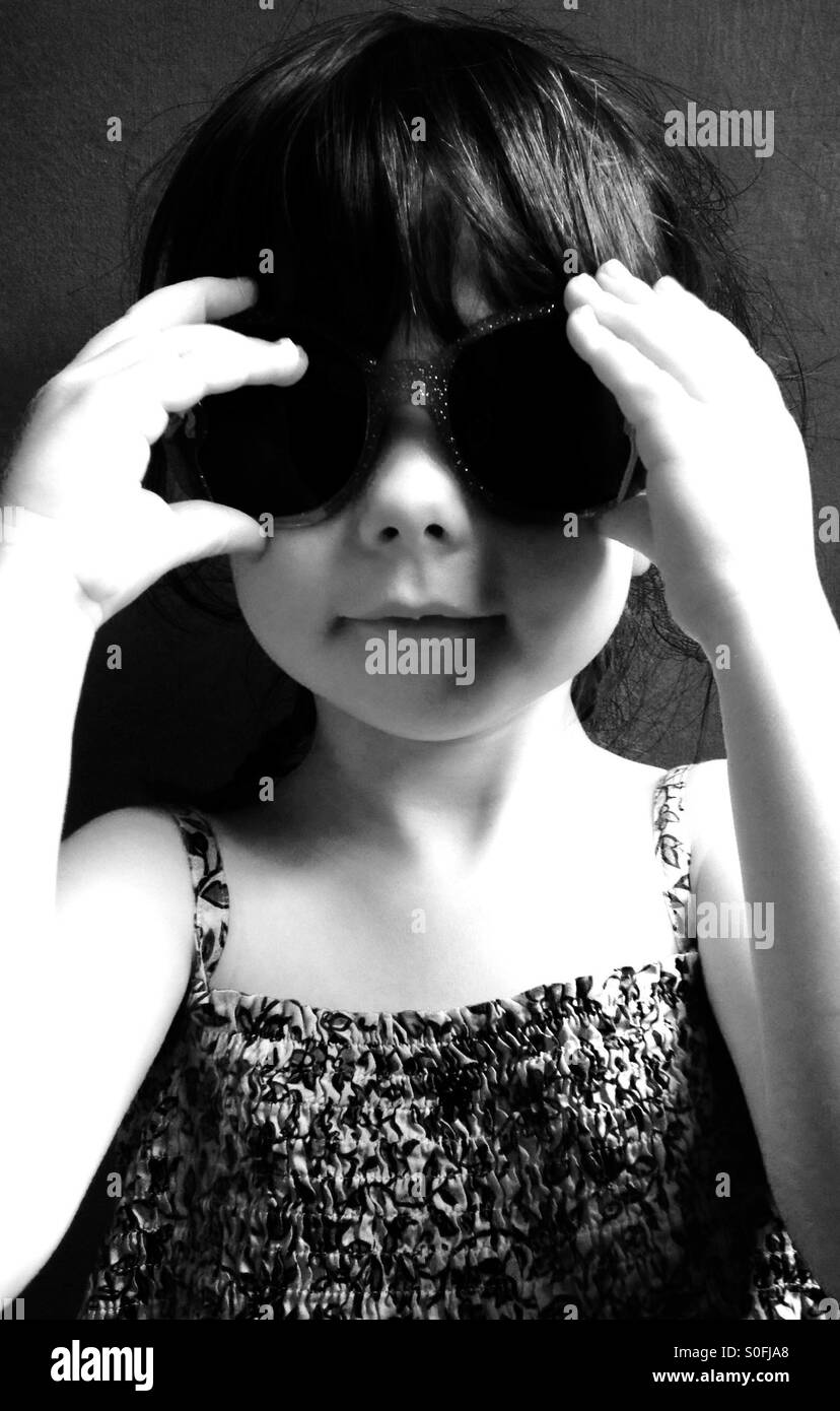 3-year old girl wearing sunglasses - Smartphone Captured Stock Image