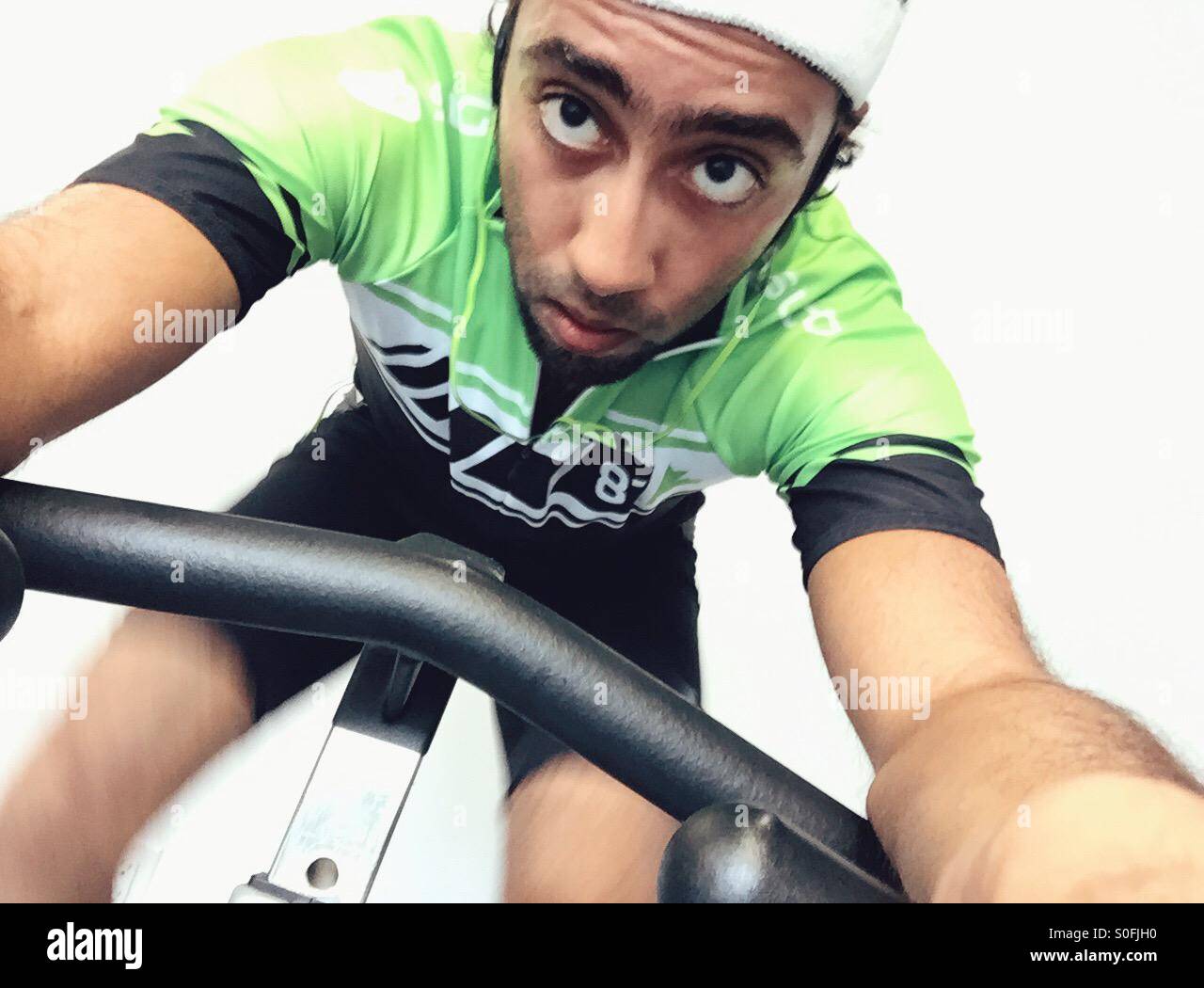 A guy on a spinning bike - Smartphone Captured Stock Image