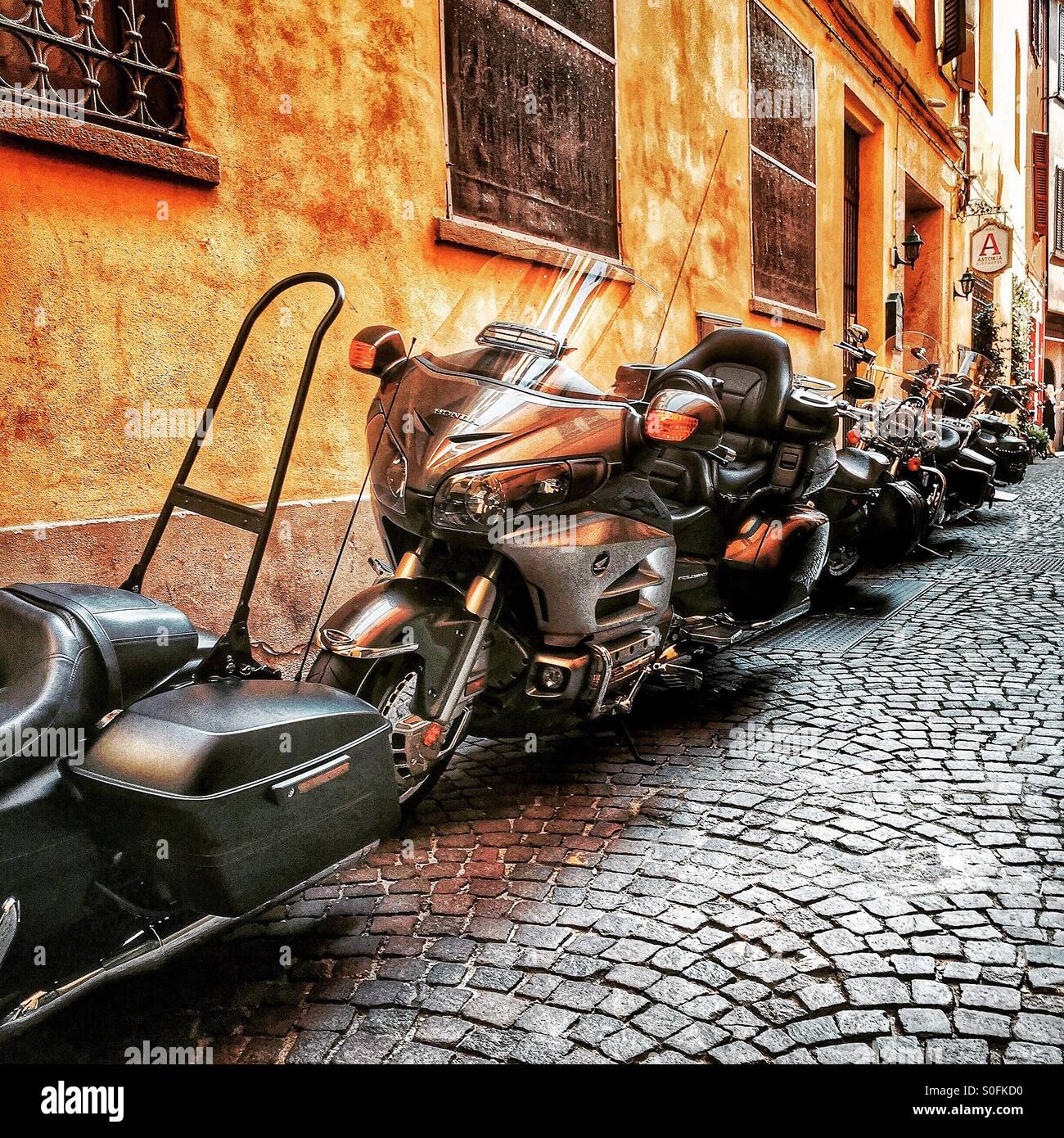 Motorcycles parked in an alley of old city - Italy - Smartphone Captured Stock Image