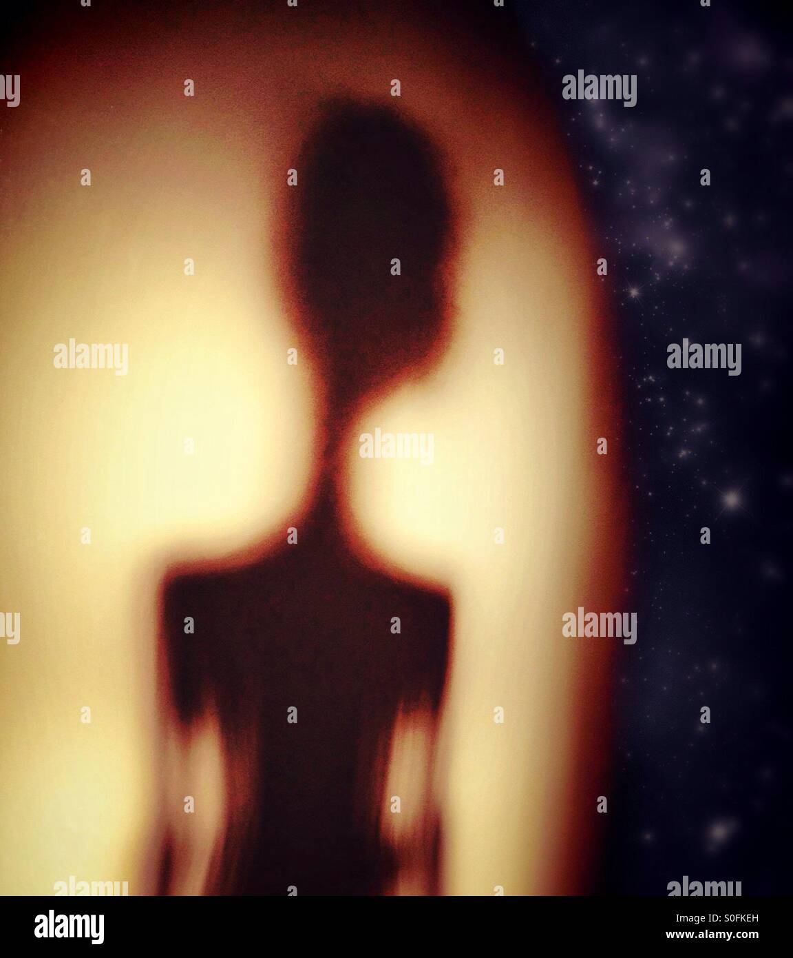 Alien figure looking out on distant stars - Smartphone Captured Stock Image