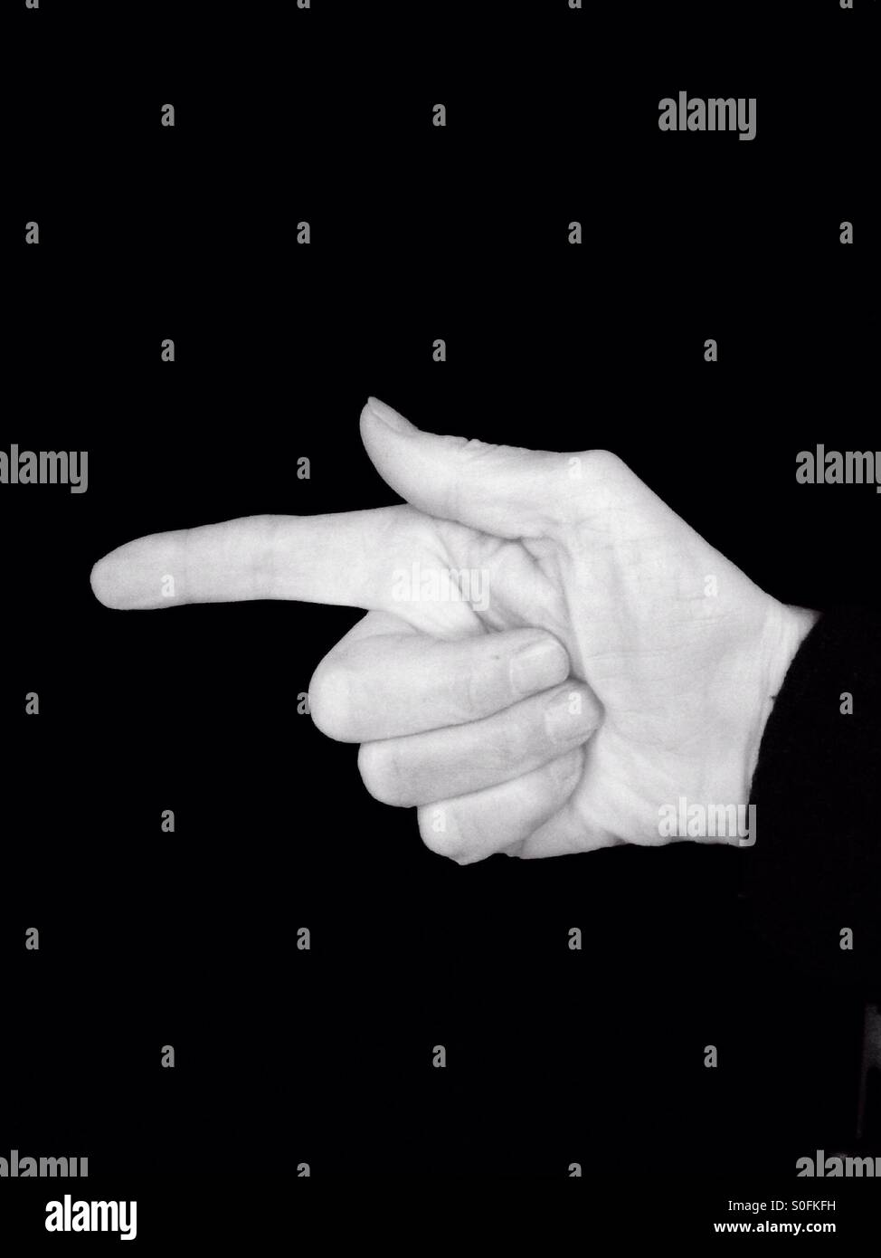 Finger pointing to the left, in black and white - Smartphone Captured Stock Image