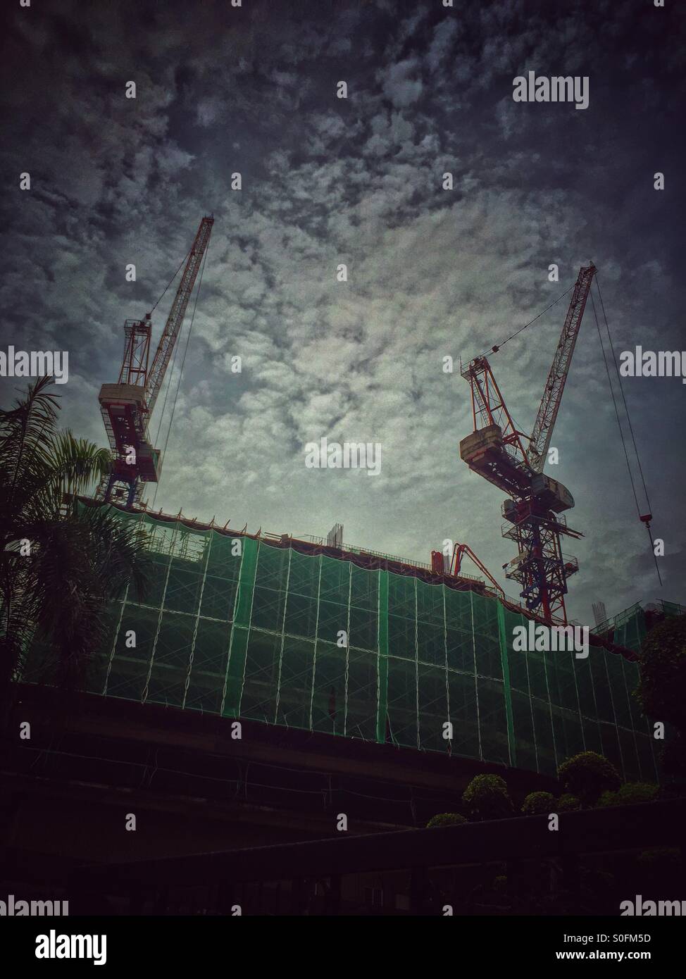 Two cranes working. - Smartphone Captured Stock Image