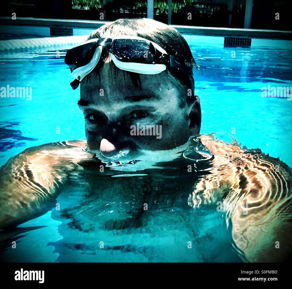 The swimmer. Daring look from man treading water during water polo match. - Smartphone Captured Stock Image