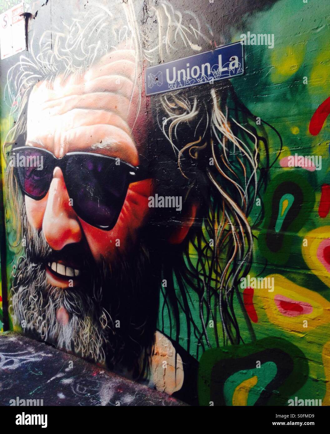 Street art of old bearded man with sunglasses and long grey hair - Smartphone Captured Stock Image