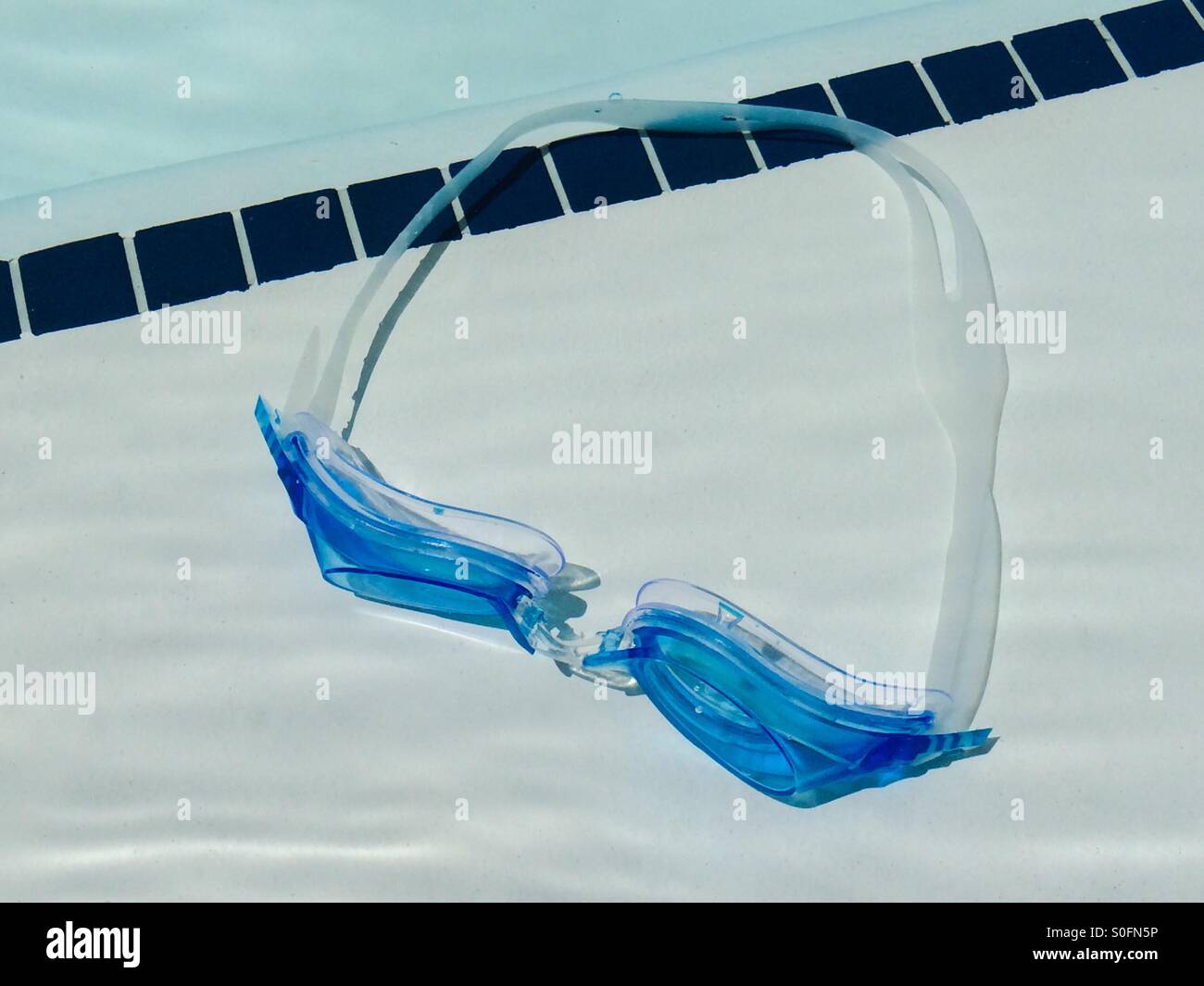 A pair of swimming goggles underwater in a pool Stock Photo Alamy