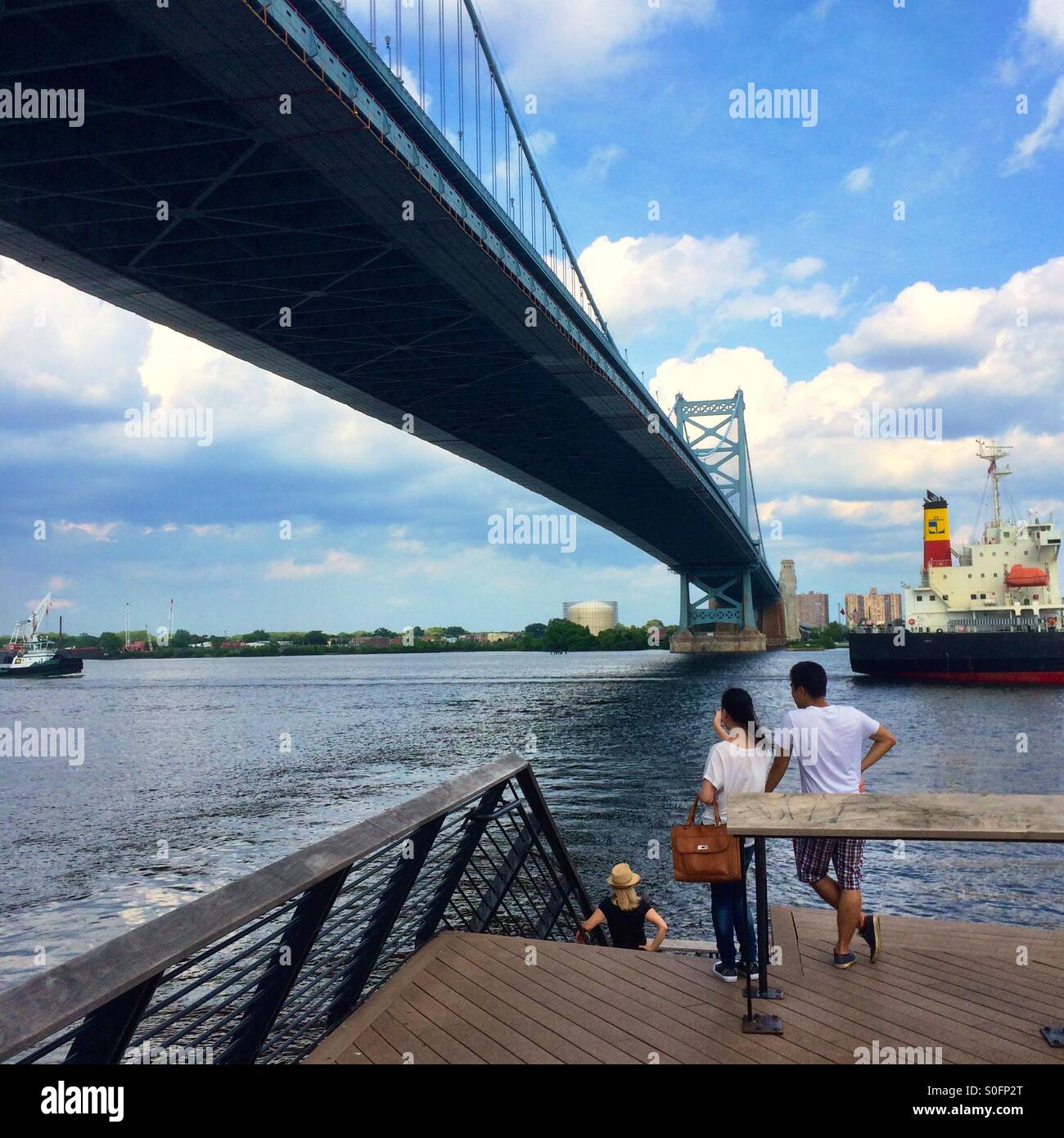 People watching boats pass, Delaware River, Ben Franklin Bridge, Philadelphia - Smartphone Captured Stock Image