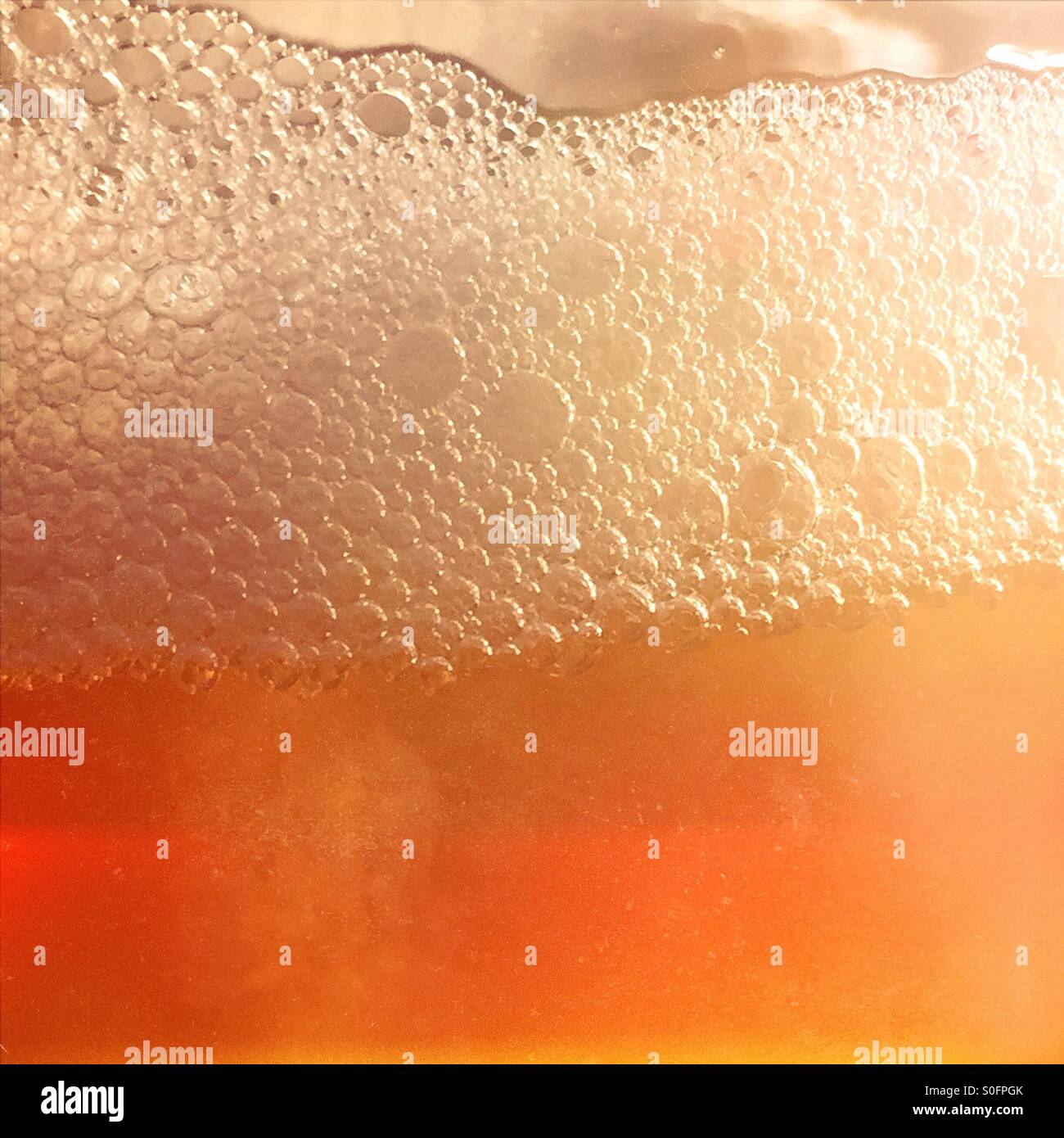Closeup of a glass of beer and foam - Smartphone Captured Stock Image