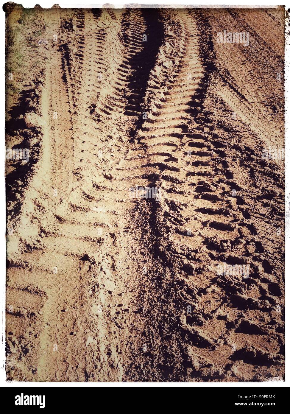 Tyre tracks on dirt road. - Smartphone Captured Stock Image