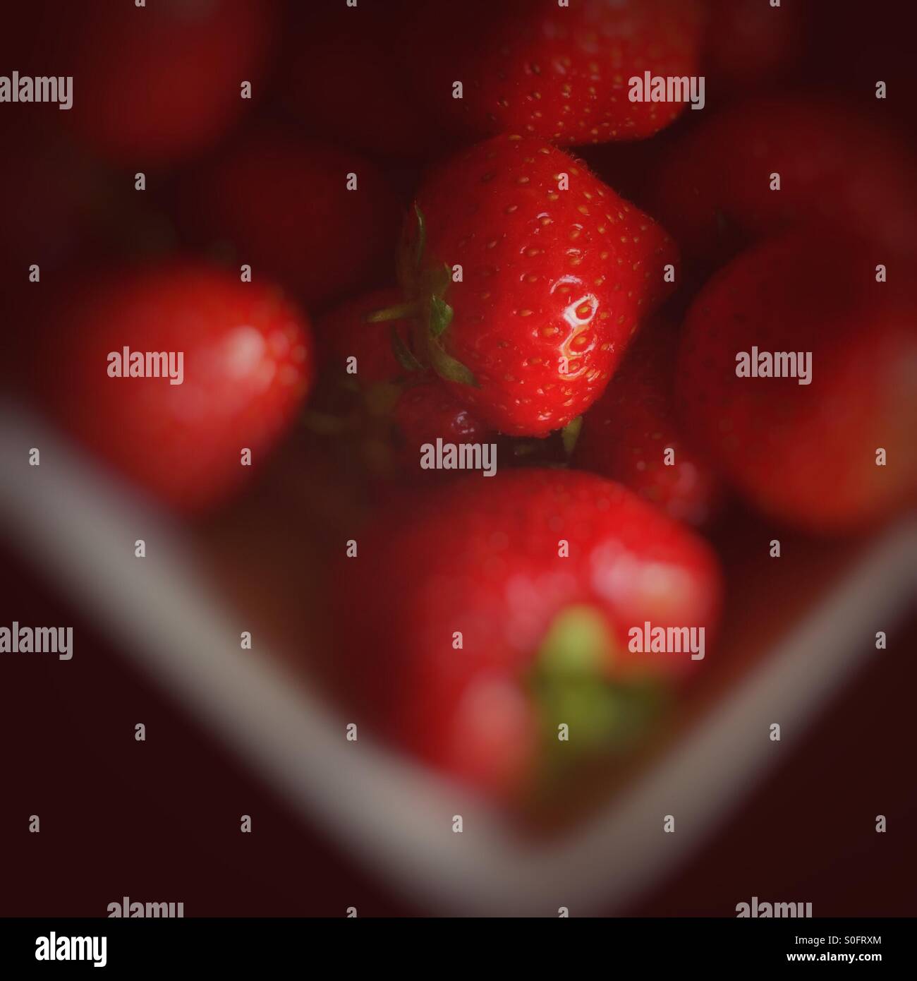 Bowl of strawberries with blur effect Stock Photo