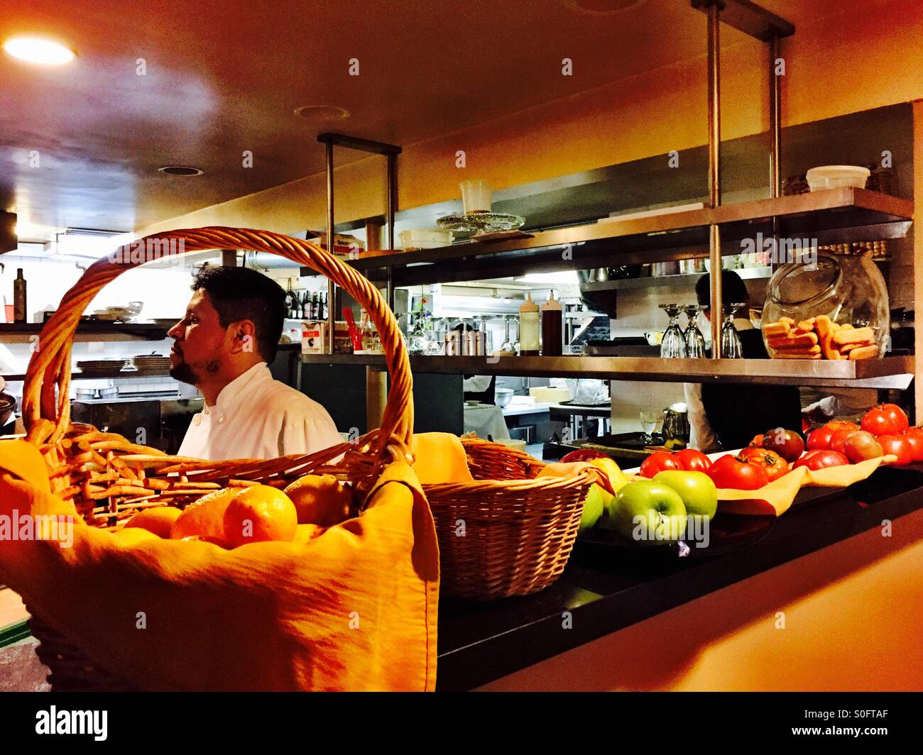 Chef focused in kitchen behind an Italian American restaurant in San Francisco, California, USA. Stock Photo