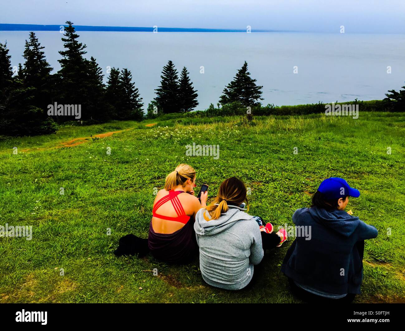 Outing by the sea, the Atlantic Ocean, Nova Scotia, Canada. Concepts: simple  joy, communing with nature, companionship, friends - Smartphone Captured Stock Image