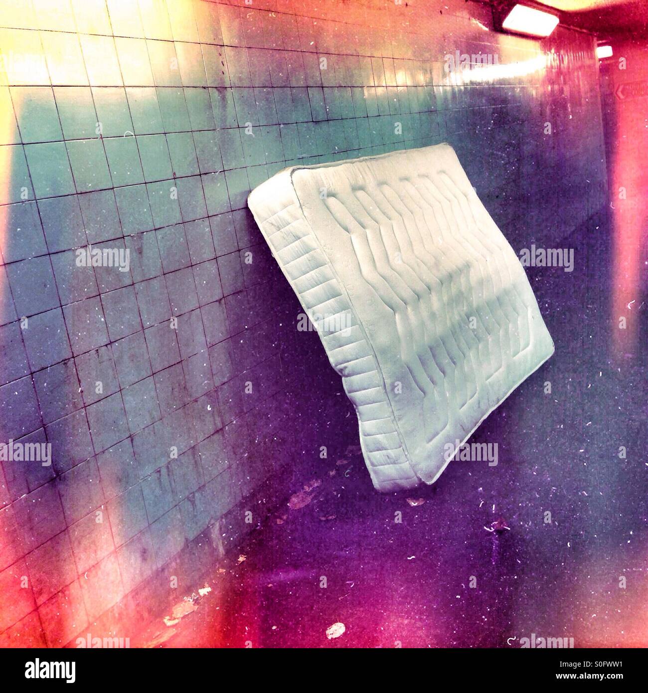 Mattress dumped by a wall Stock Photo Alamy