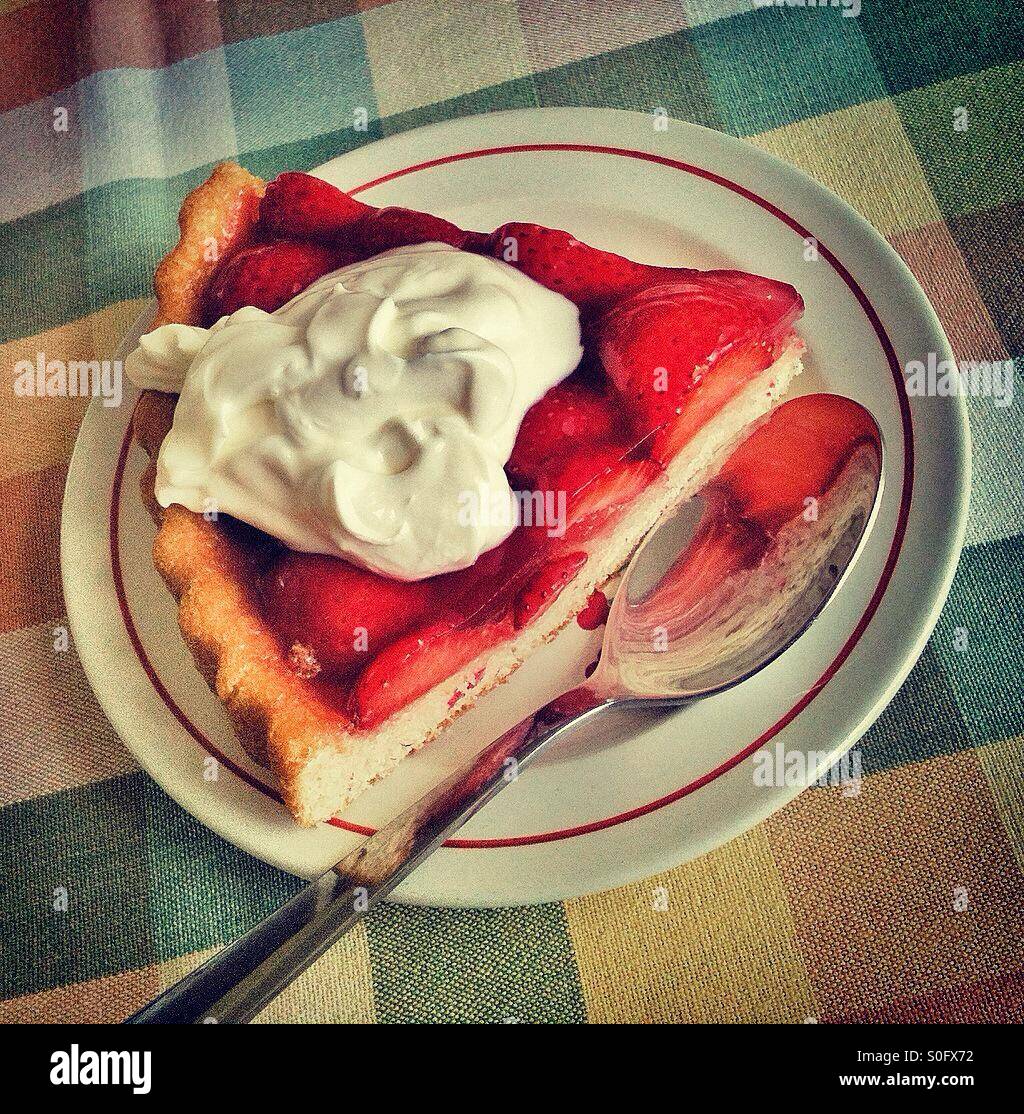 Strawberry flan slice topped with Greek style yoghurt. - Smartphone Captured Stock Image