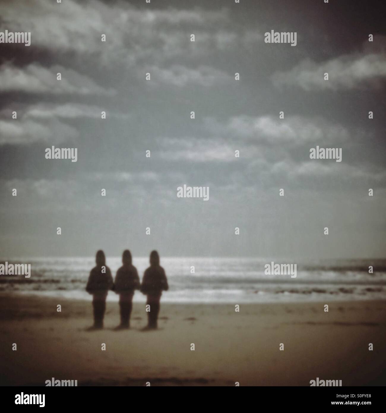 Three stood together on Bournemouth beach - Smartphone Captured Stock Image