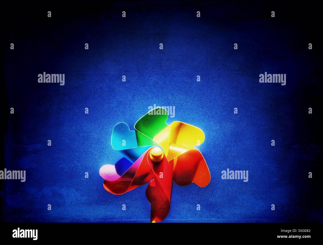 Childs toy windmill against blue sky - Smartphone Captured Stock Image