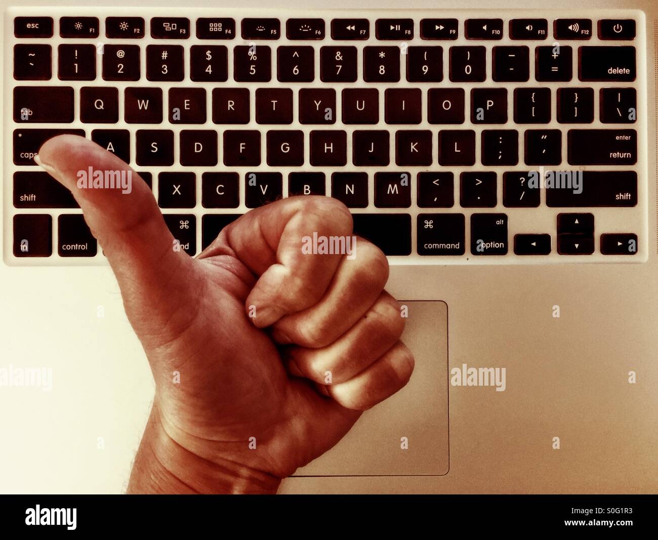 Thumbs up over keyboard. - Smartphone Captured Stock Image