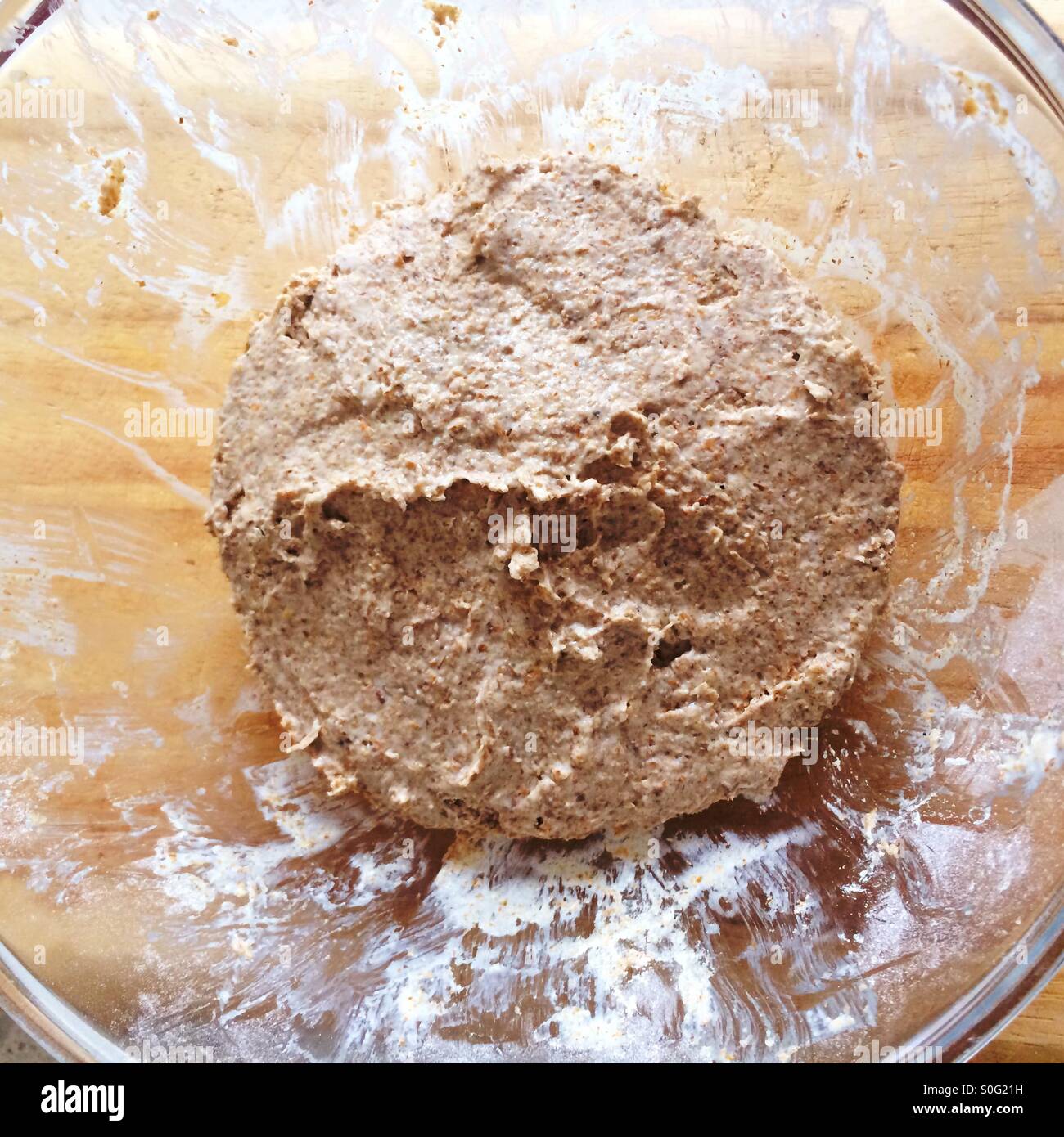 Rye sourdough starter in glass mixing bowl on light coloured timber
