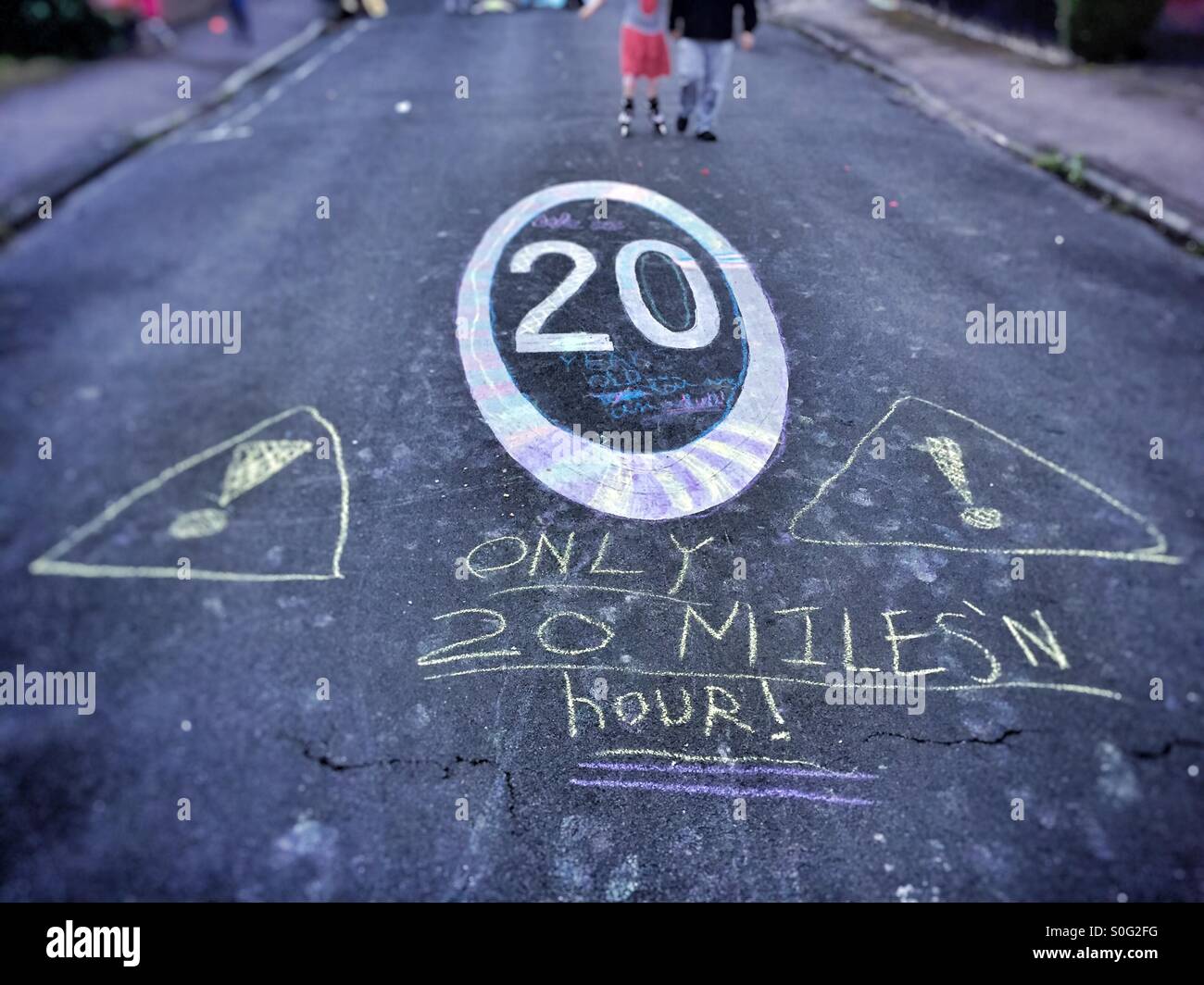 Speed limit sign on residential street. With children's graffiti, road safety. Stock Photo