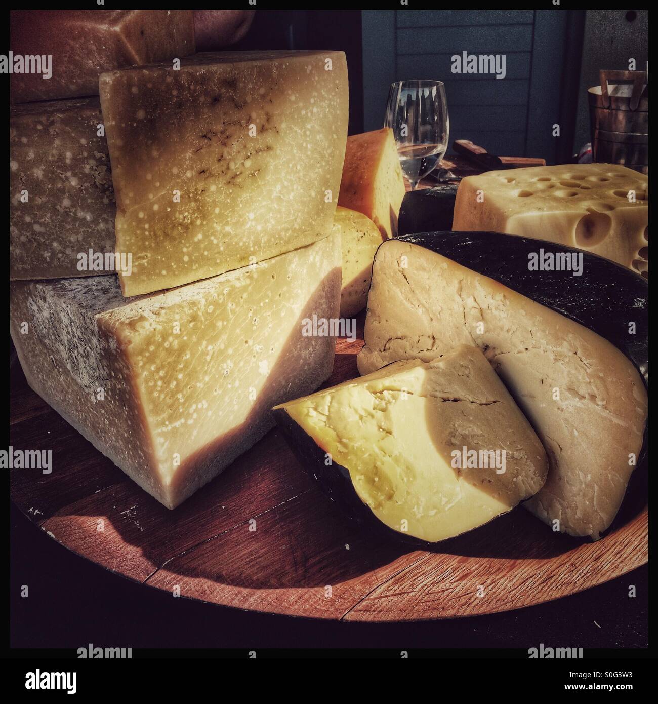 Selection of hard cheeses on board. Stock Photo