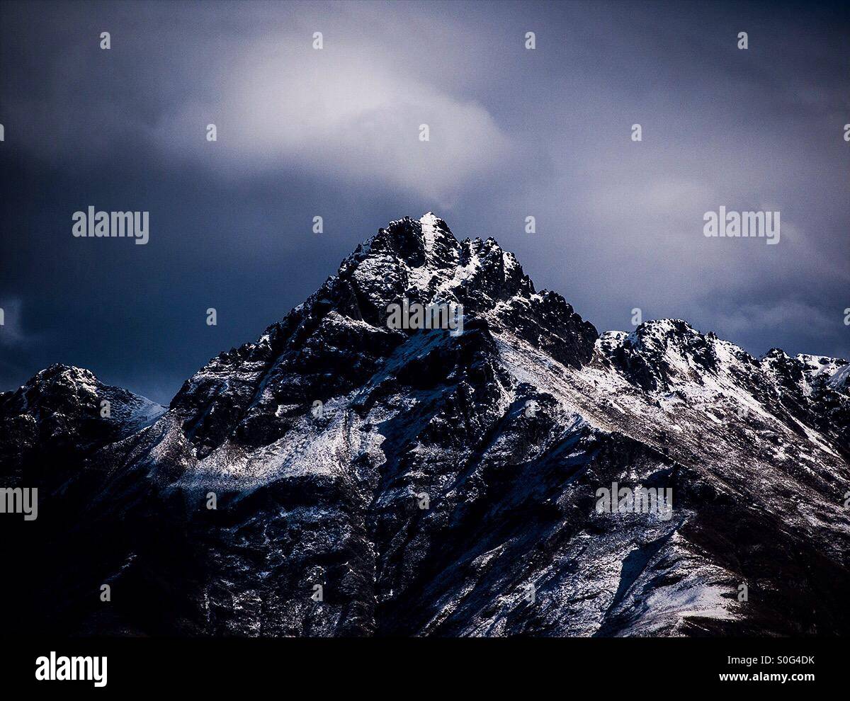 Dark and stormy mountain peak in New Zealand. Land of the hobbits. Stock Photo