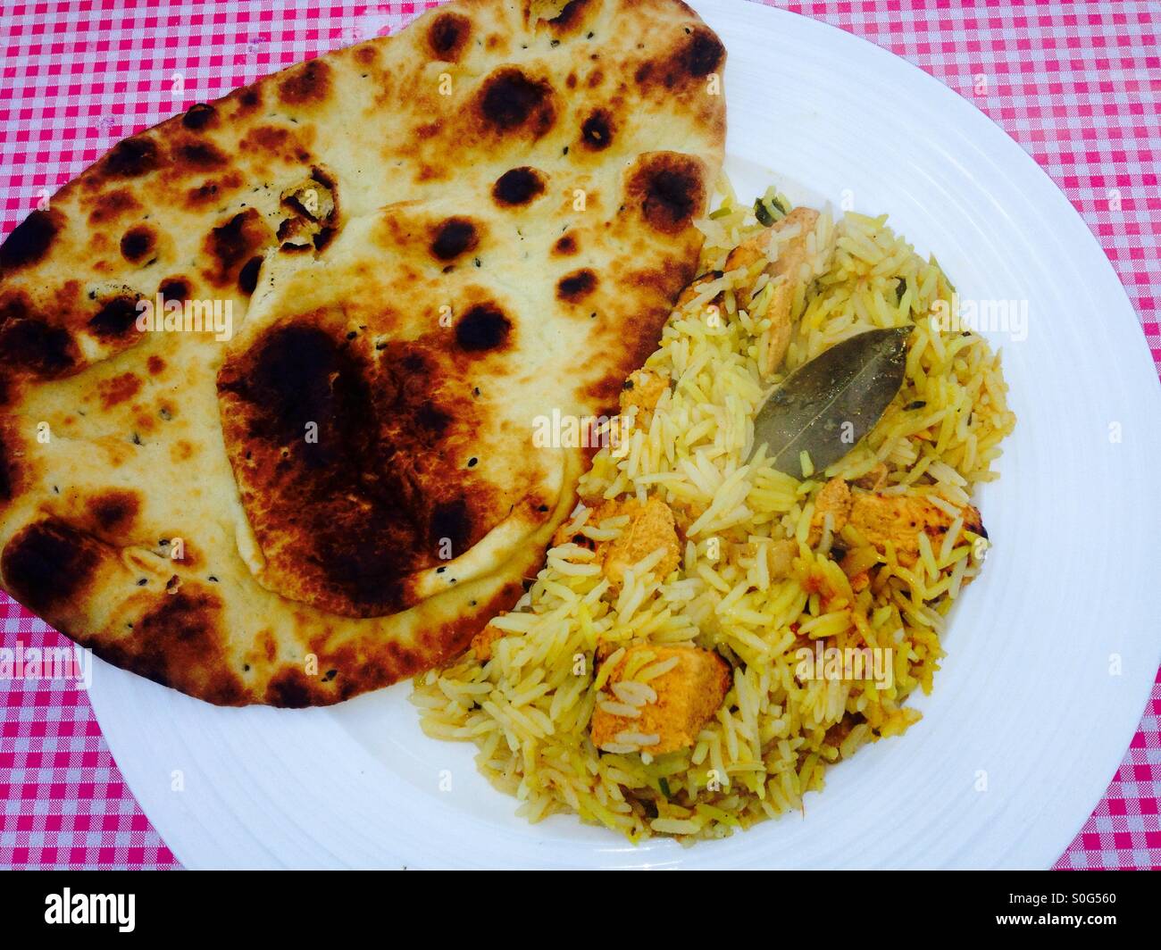 Chicken biryani curry with flame baked naan bread - Smartphone Captured Stock Image