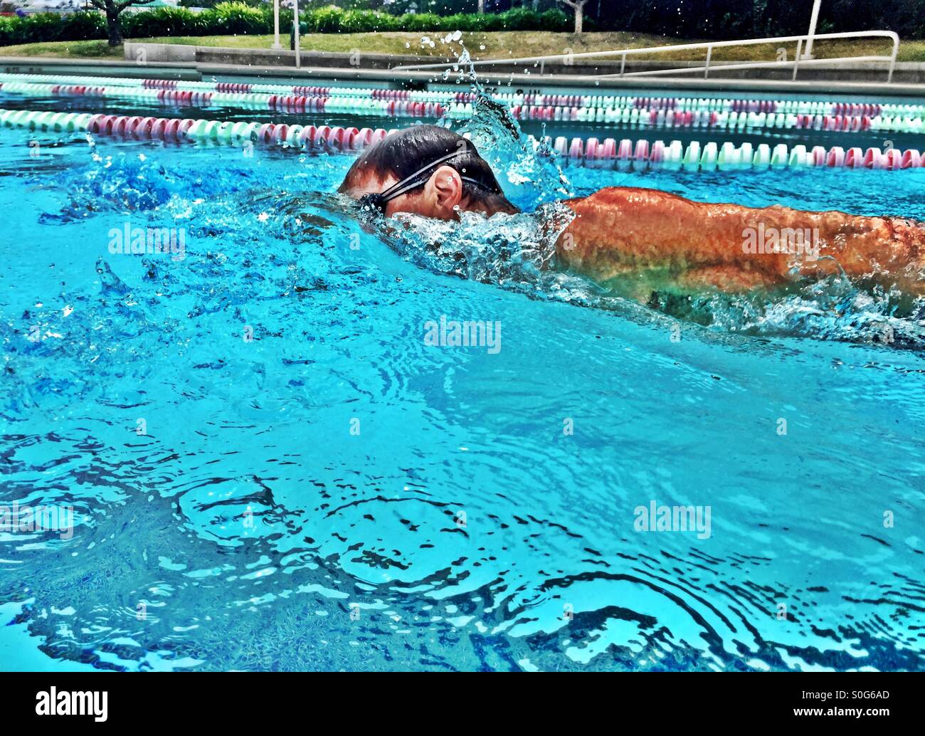 In the wake of a swimmer. Closeup, in mid stroke. - Smartphone Captured Stock Image