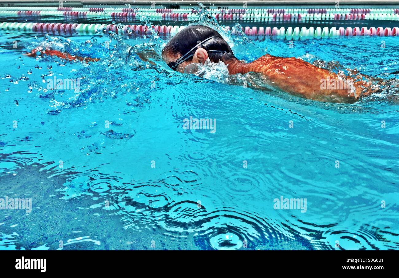 Swimmer fiercely plows into the water. - Smartphone Captured Stock Image