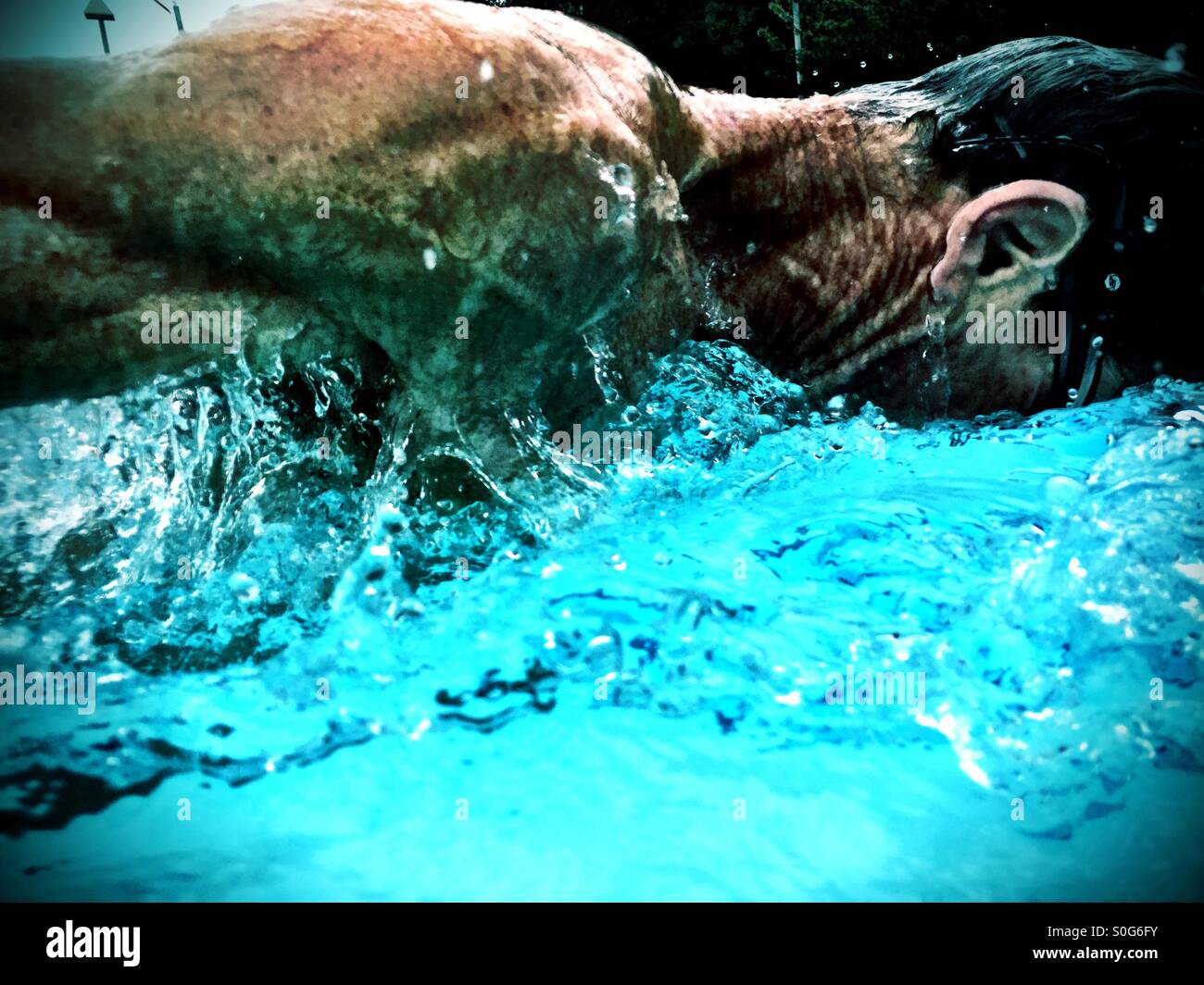 The swimmer. Extreme closeup of male athlete swimming butterfly. - Smartphone Captured Stock Image