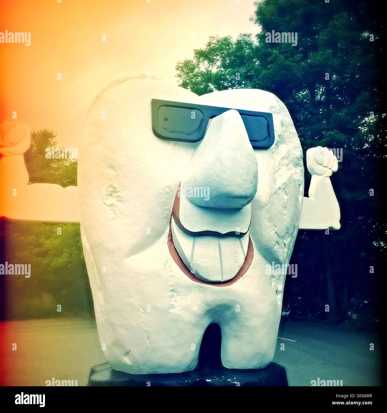 Huge tooth carved wood caricature statue in front of dentist office