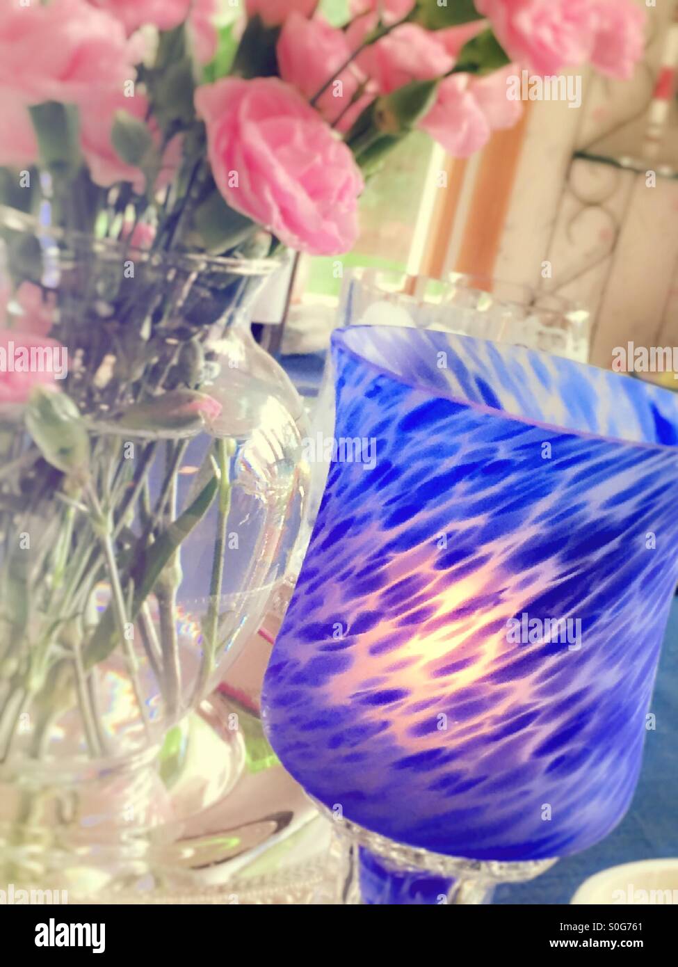 Bright blue votive candle on the dining room table, USA - Smartphone Captured Stock Image