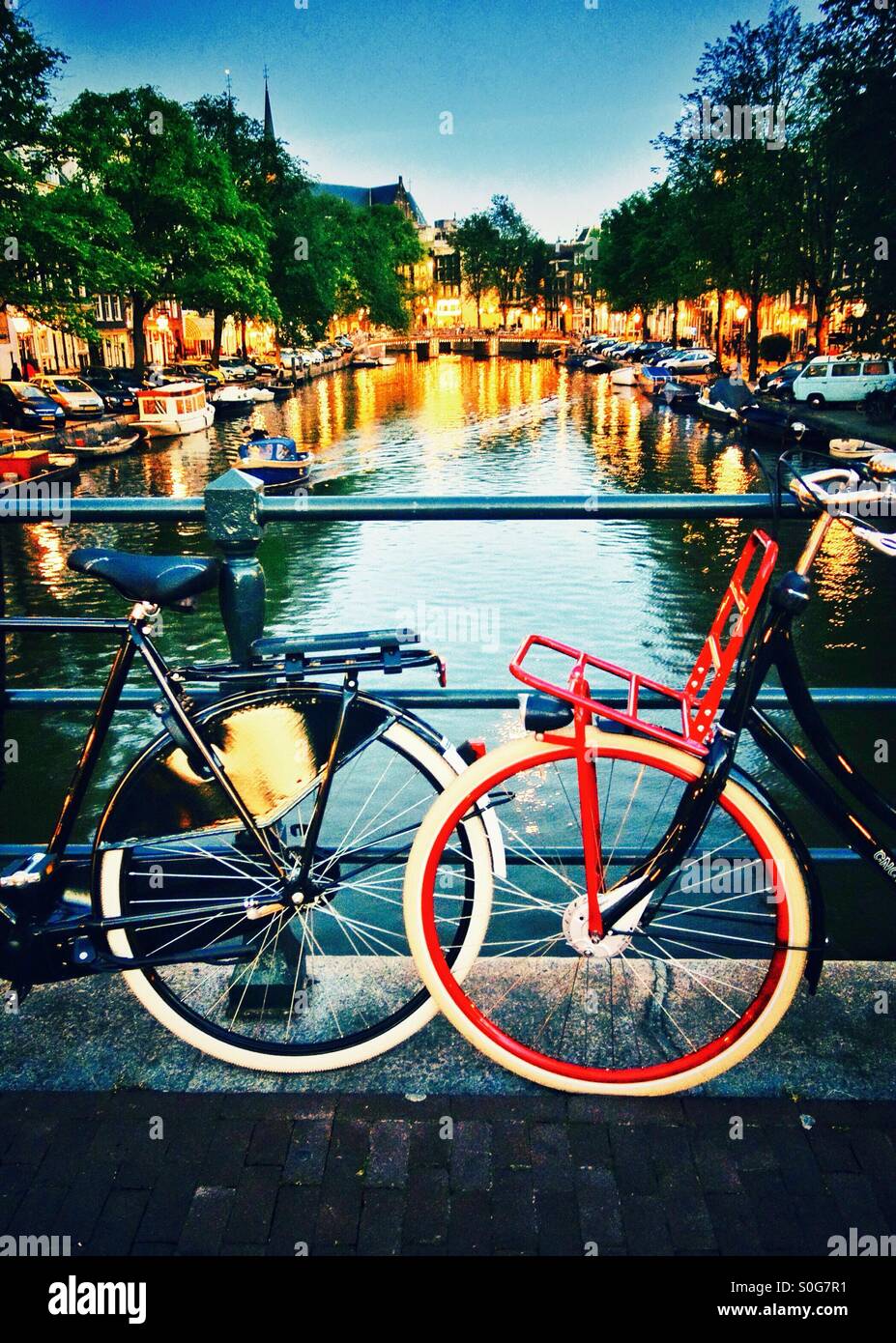 A couple's bicycles parked on a bridge in Amsterdam Netherlands EU - a romantic weekend city break - Smartphone Captured Stock Image