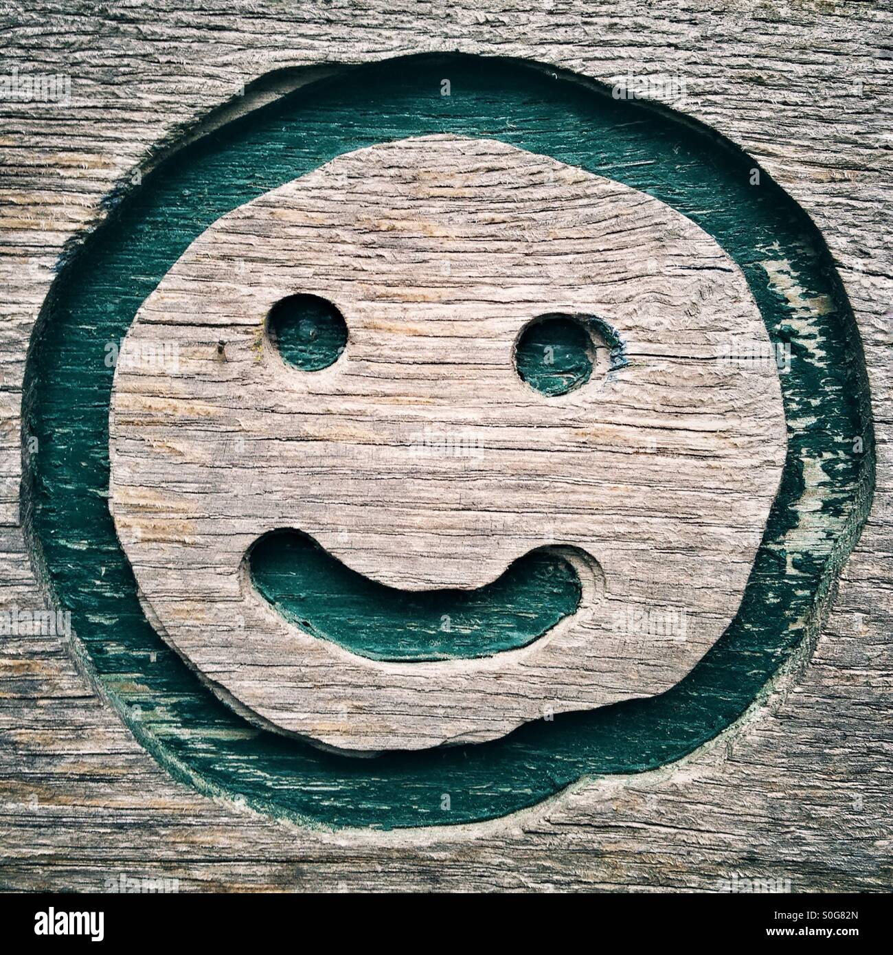 Smiley Face Carved in Wood Stock Photo