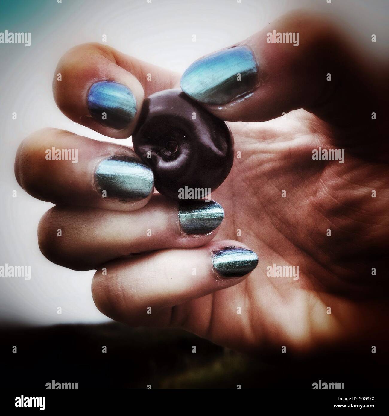 Woman's hand holding a cherry - Smartphone Captured Stock Image