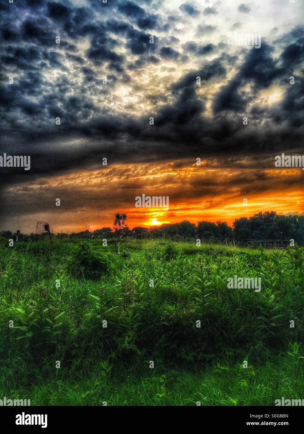 Amazing sunset over the rolling fields. Stock Photo