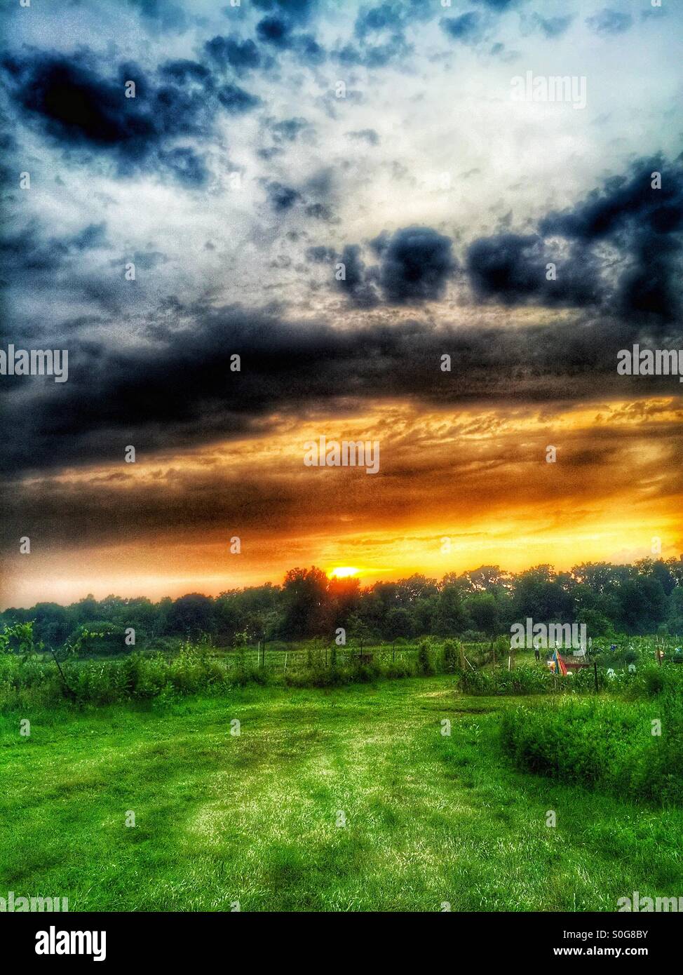 Dazzling sunset over the farm Stock Photo