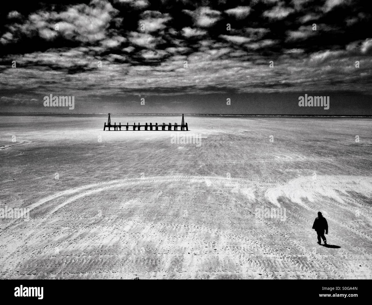 Solo figure on beach at Lytham St Annes in Lancashire - Smartphone Captured Stock Image