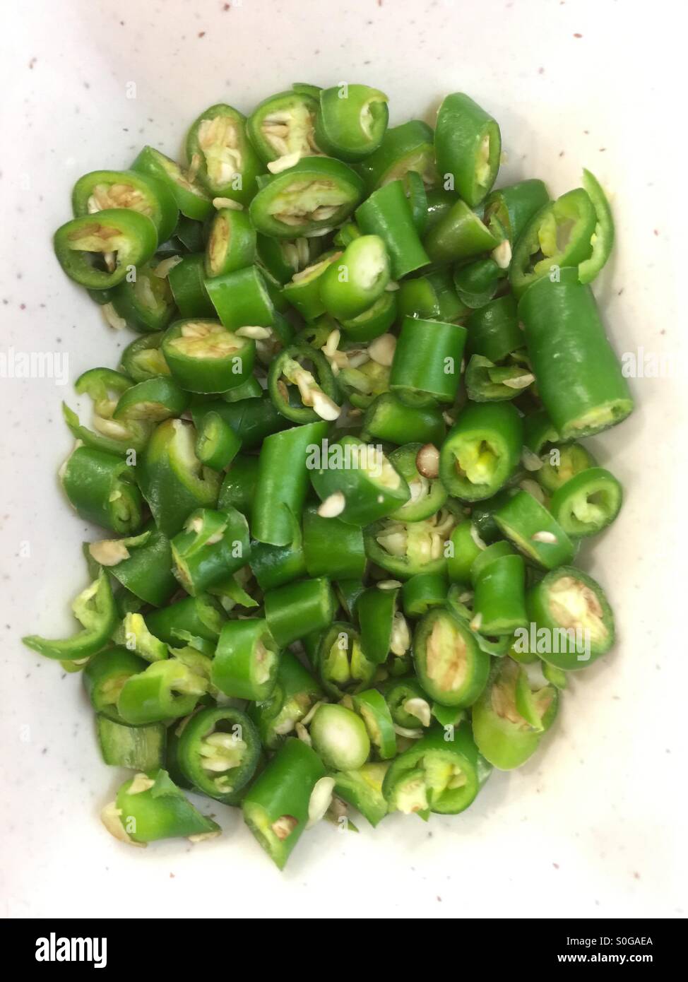Top view of a bowl of mixed cut green chillies - Smartphone Captured Stock Image