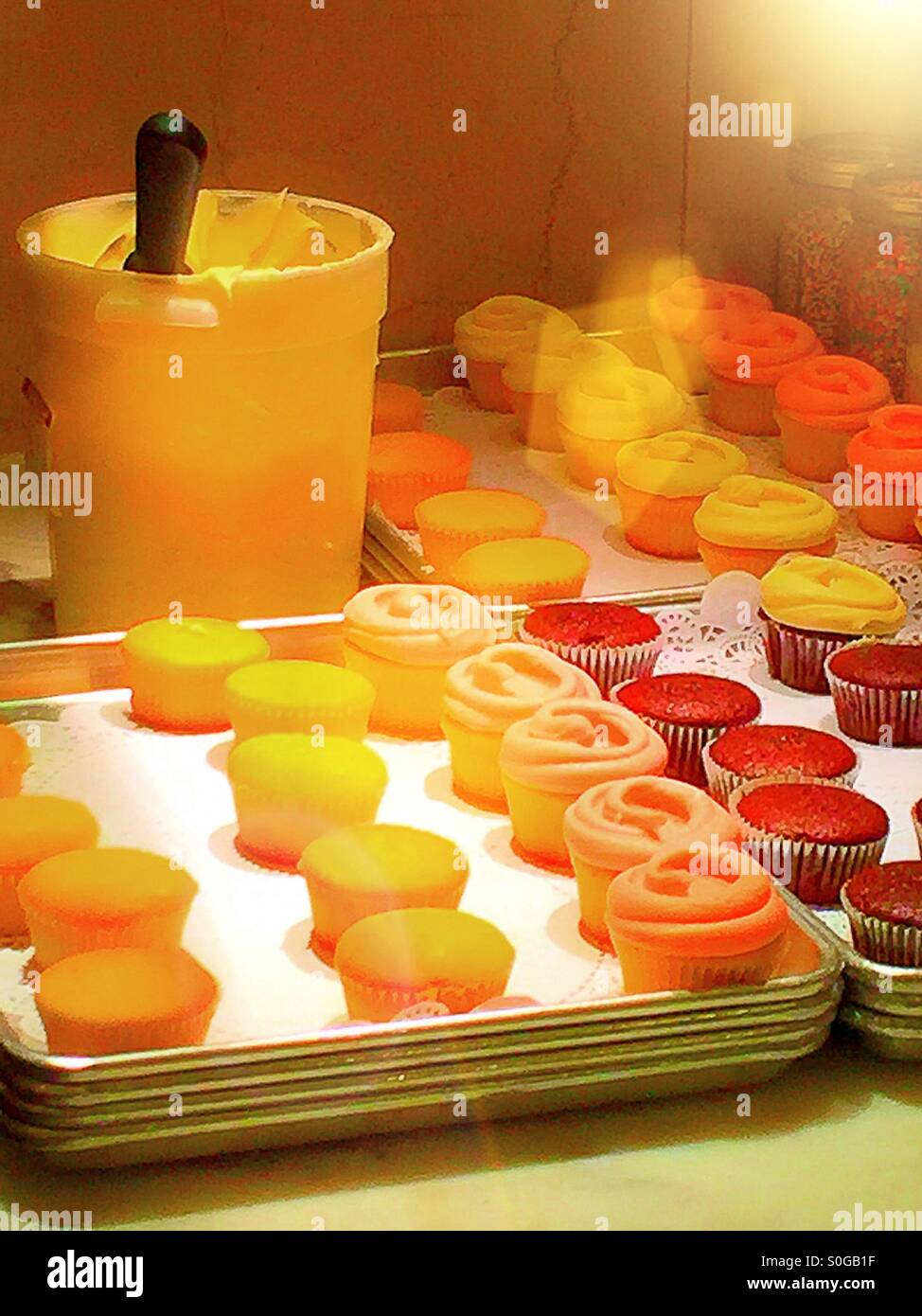 Cupcakes being frosted at bakery workstation. - Smartphone Captured Stock Image