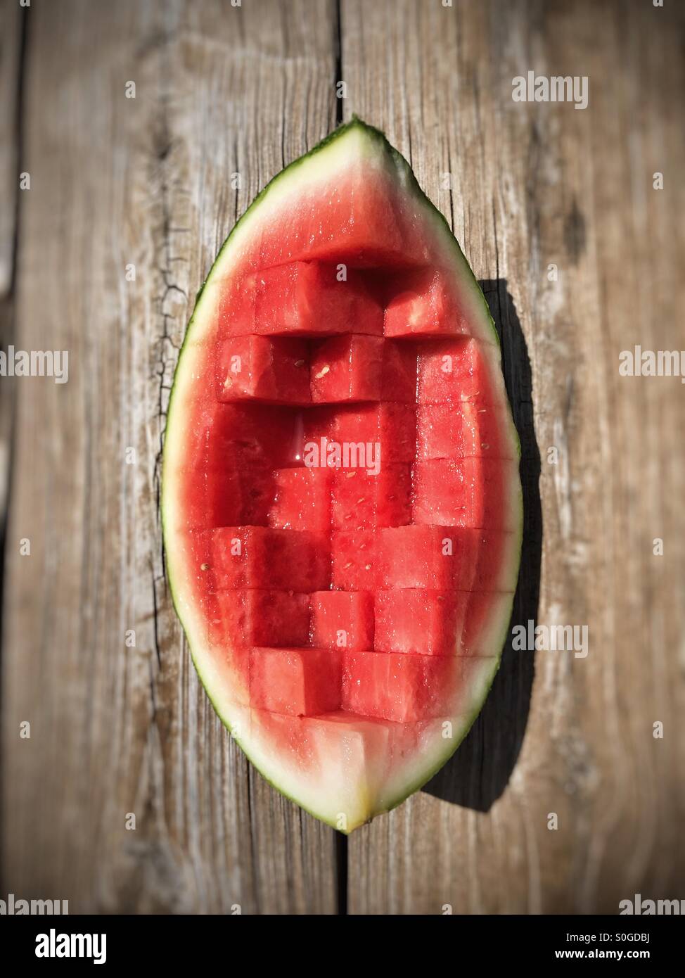 Quarter of a watermelon sliced into cubes Stock Photo