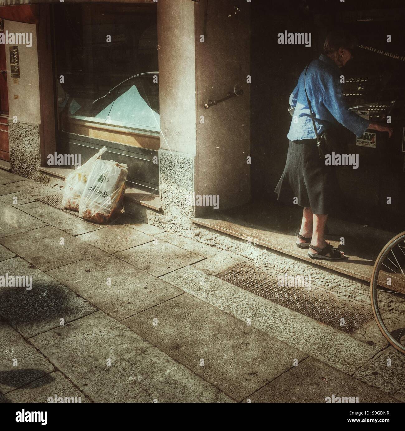 City rubbish outside a pastry shop and customer entering - Smartphone Captured Stock Image