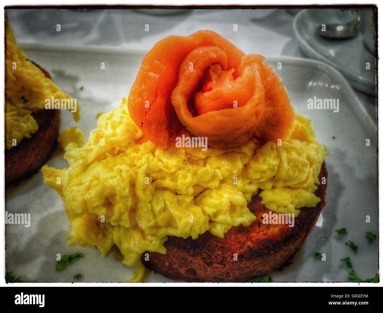 Scrambled eggs and salmon on toasted brioche. - Smartphone Captured Stock Image