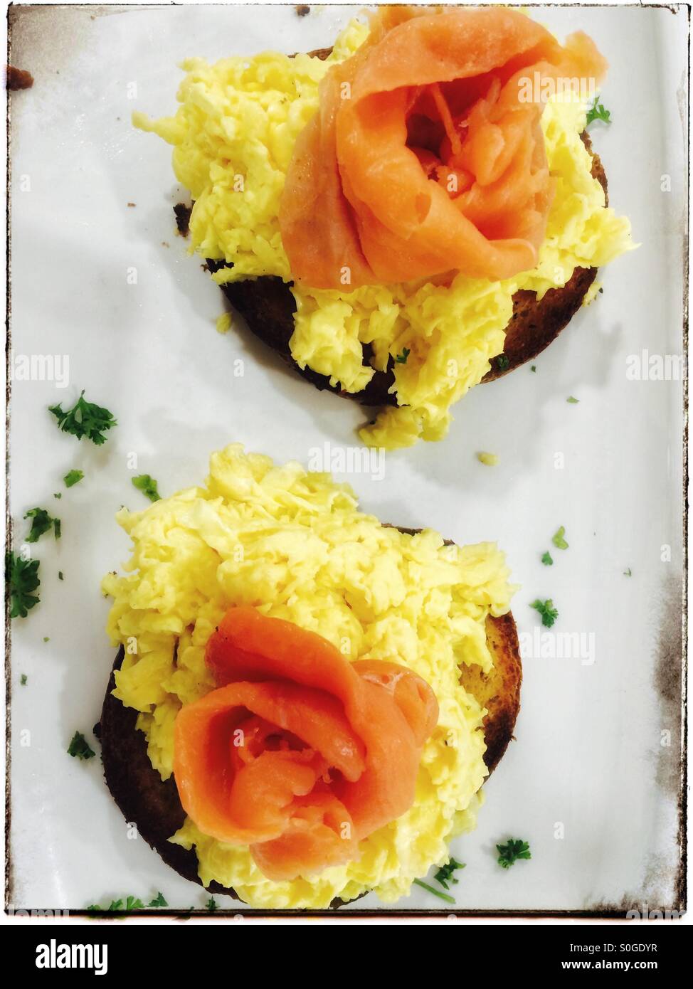 Toasted brioche with scrambled eggs and salmon. - Smartphone Captured Stock Image