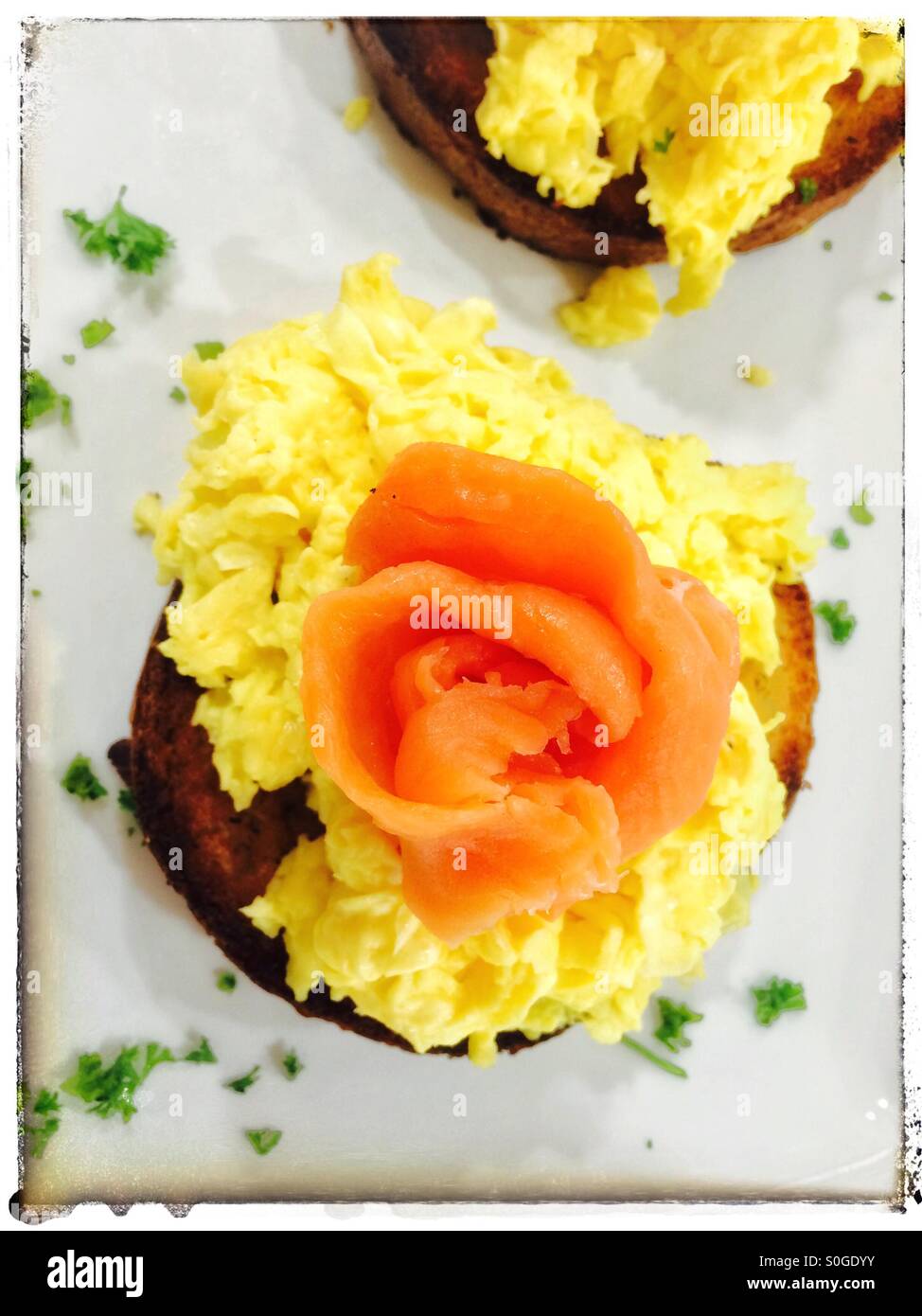 Scrambled eggs and salmon on toasted brioche. - Smartphone Captured Stock Image