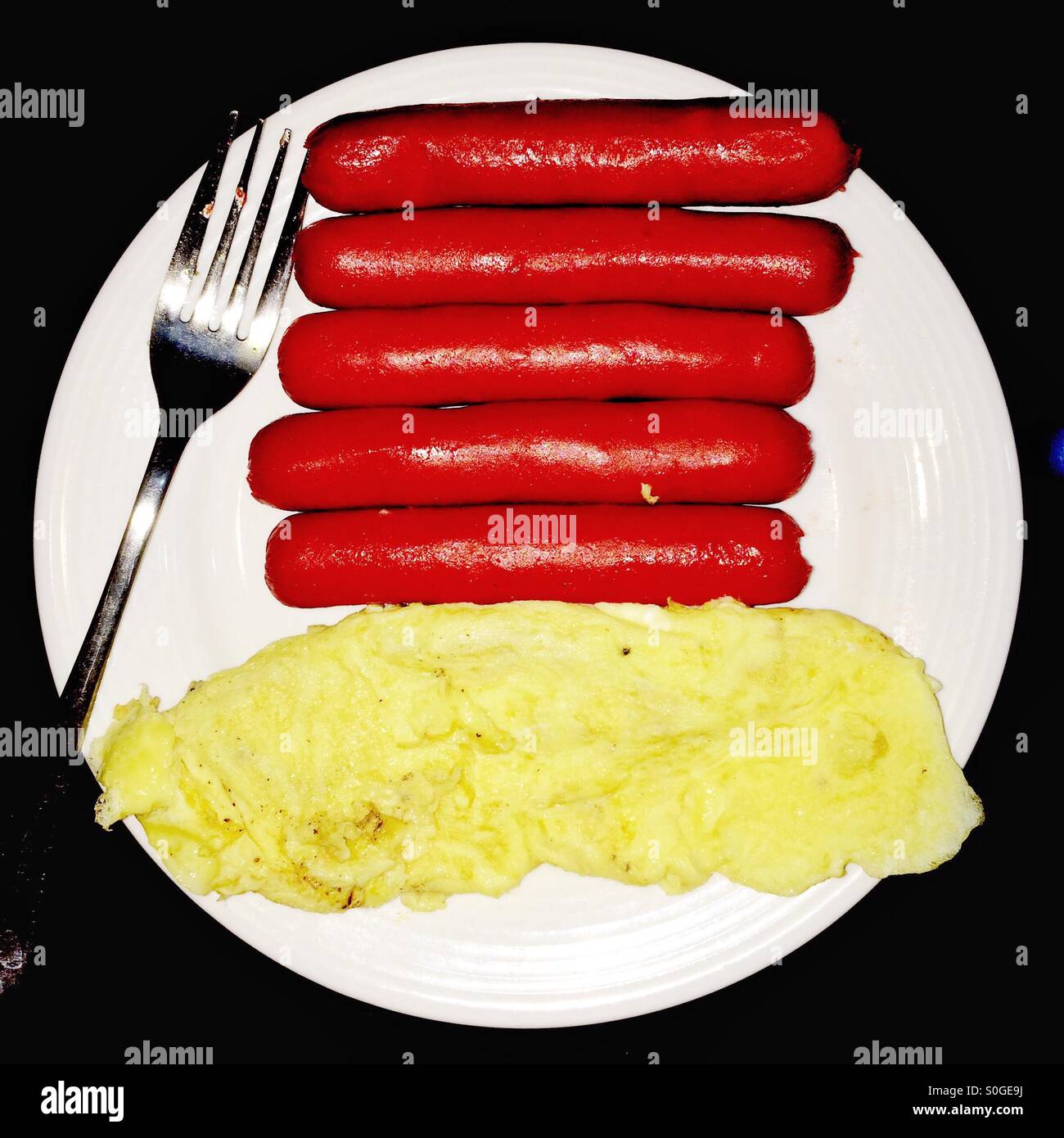 Scrambled egg and hotdogs for breakfast. Stock Photo