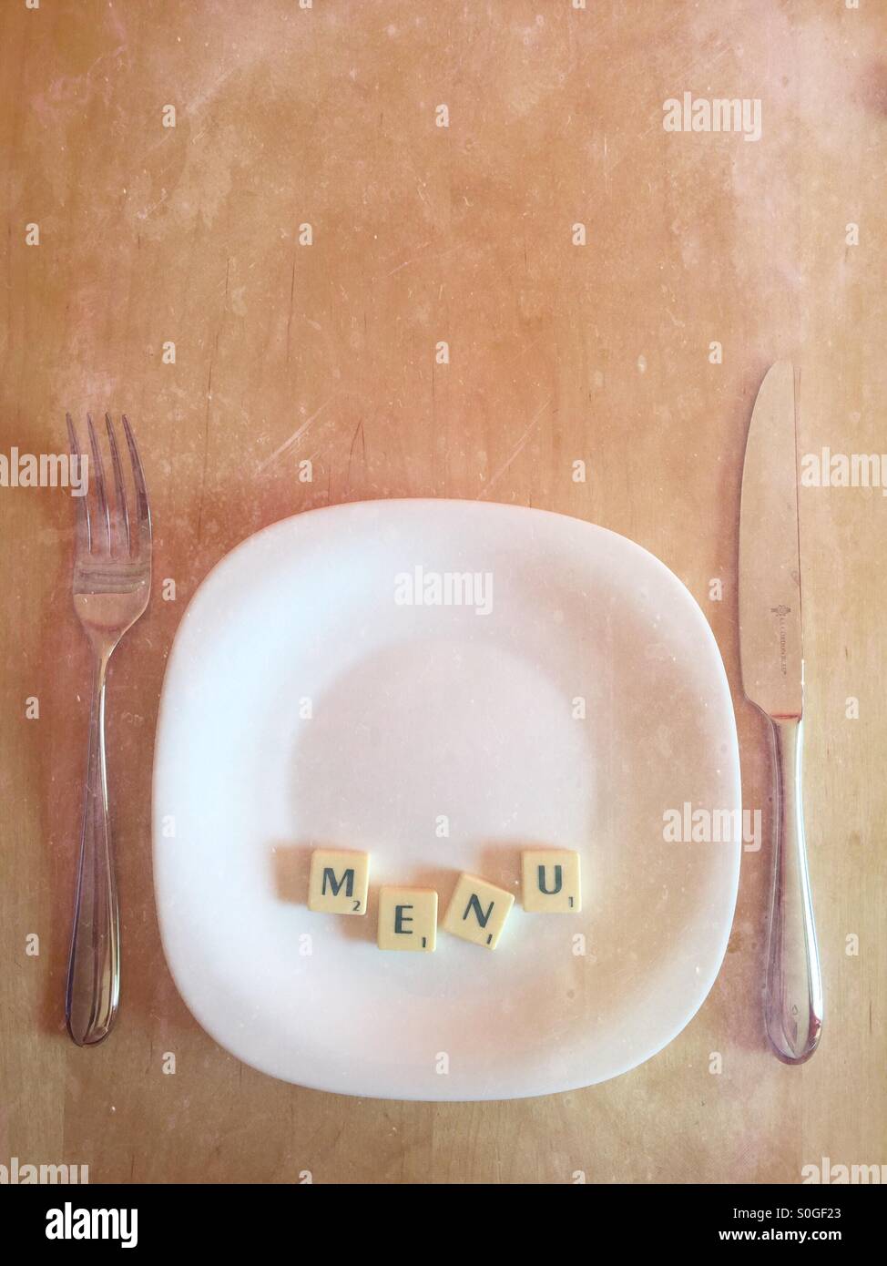 Plate with scrabble word MENU with chalkboard feel - Smartphone Captured Stock Image