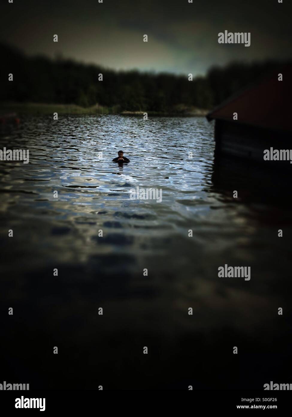 Diver testing dry suit in baltic sea cove - Smartphone Captured Stock Image