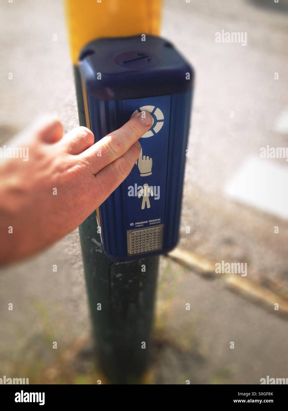 Fingers pressing button on Swedish road crossing traffic lights - Smartphone Captured Stock Image