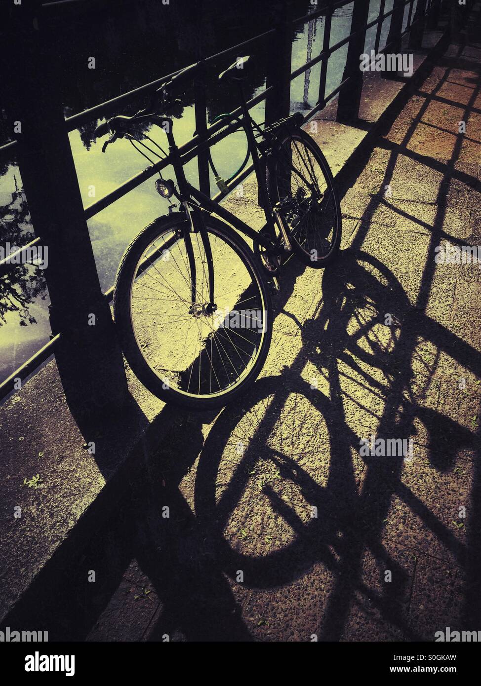 Locked bicycle by river Spree Berlin Germany Stock Photo