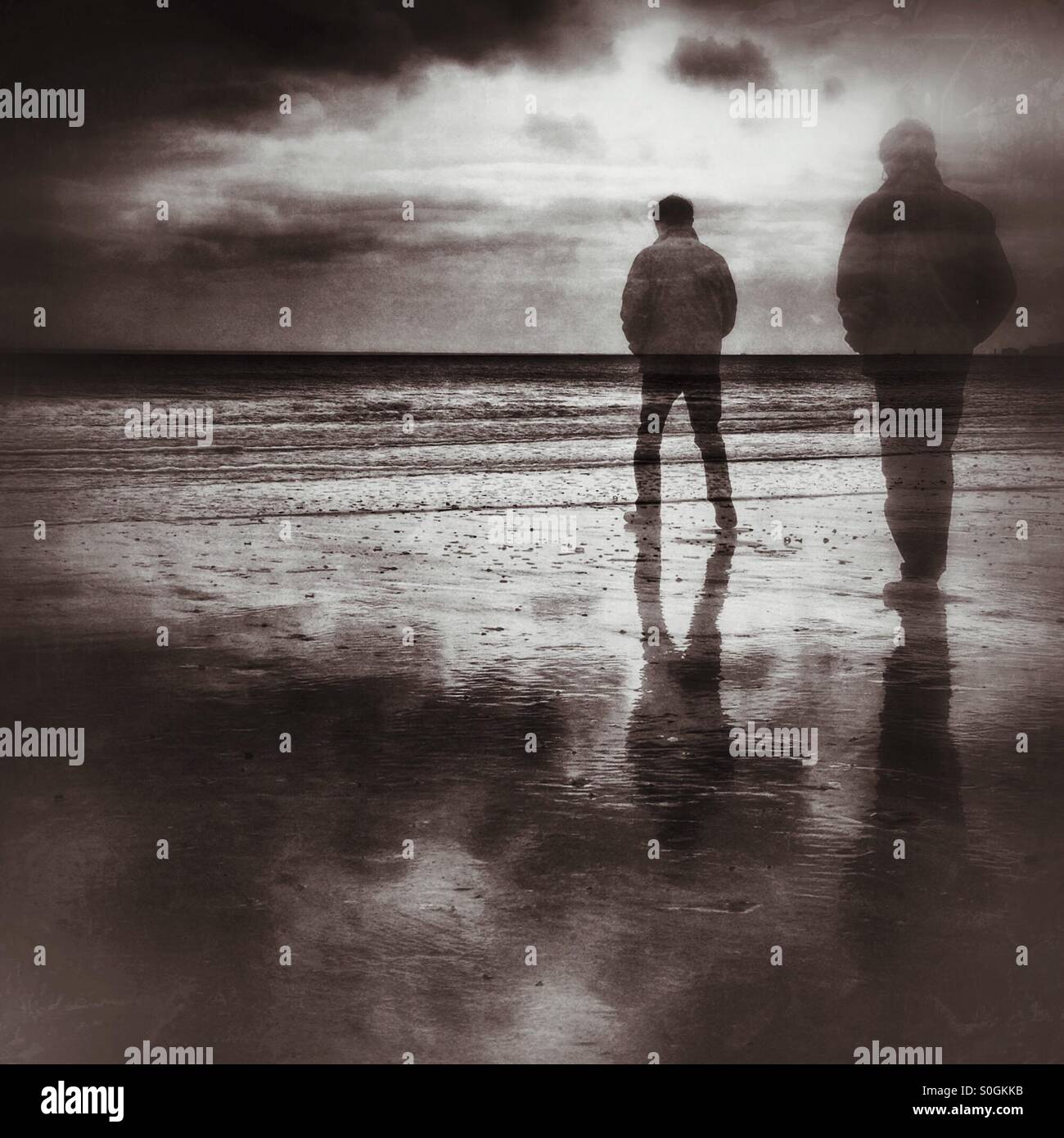 Figures walking towards the sea - Smartphone Captured Stock Image