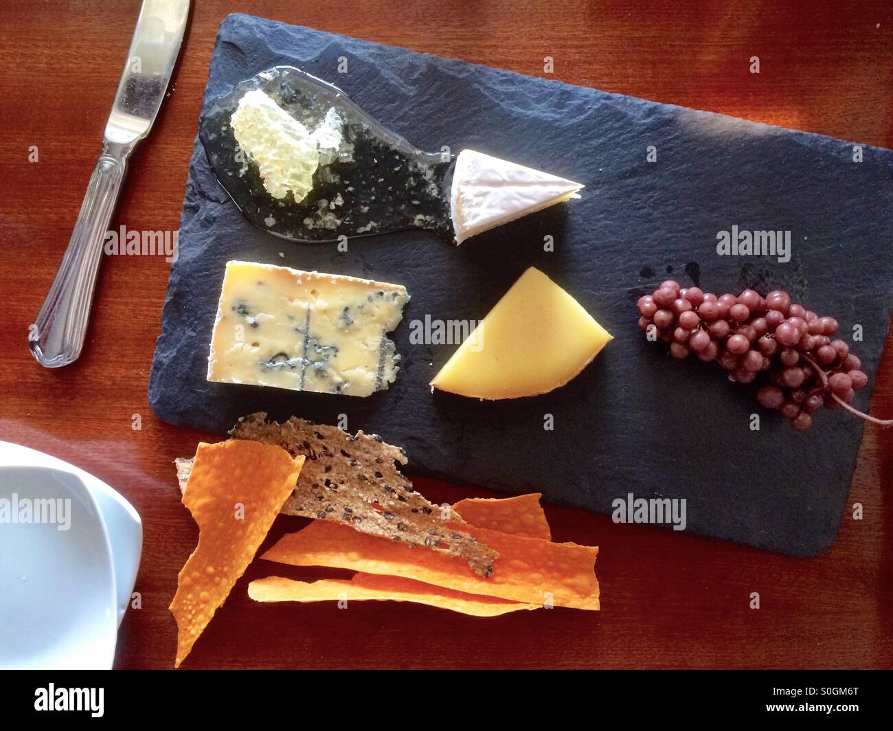 Cheese Board featuring Vermont cheeses and honey Stock Photo